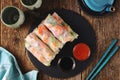 Rice spring rolls - rice paper, carrots, watermelon radish, tomato, cucumber, coriander and fried shrimp. Healthy food.