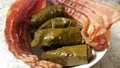 Rice stuffed grape leaves with bacon strips in bowl