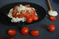 Rice with sauce, meatballs and parmesan next to a fork and cherry tomatoes Royalty Free Stock Photo