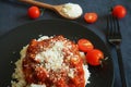 Rice with sauce, meatballs and parmesan next to a fork and cherry tomatoes Royalty Free Stock Photo