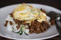 Rice topped egg with stir-fried pork and basil