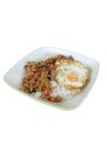 Rice topped with stir-fried chicken and holy basil, fried egg, white background. Royalty Free Stock Photo