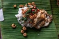 Rice topped with Stir fried Thai basil with dwarf prawn and Fried egg on served a banana leaf