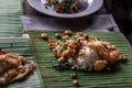 Rice topped with Stir fried Thai basil with dwarf prawn and Fried egg on served a banana leaf