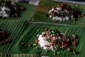 Rice topped with Stir fried Thai basil with minced pork Pad Ka Prao Moo on served on a banana leaf