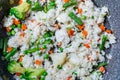 Rice with vegetables - peas, carrots, green beans. Vegetarian healthy food Royalty Free Stock Photo