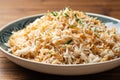 Rice with vermicelli in plate on wooden background. Traditional arabic dish