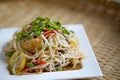 Rice vermicelli spicy salad on dish background blur.