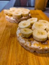 Rice waffles with peanut butter and banana laying on wooden cutting board Royalty Free Stock Photo