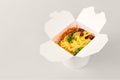 Rice wok with seafood and vegetables in white box isolated on grey background, takeaway food Royalty Free Stock Photo