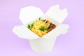 Rice wok with seafood and vegetables in white box isolated on purple background, takeaway food Royalty Free Stock Photo