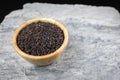 Riceberry in a wooden cup placed on stone slabs