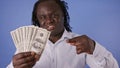 Rich african american black man pointing finger on the money fan