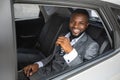 Rich african american businessman smiling through car window Royalty Free Stock Photo