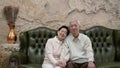Rich Asian senior parents sit in luxury beautiful house background