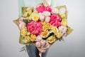 Rich bouquet flowers of different colors mixed in woman hand . Royalty Free Stock Photo