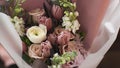 A rich bouquet of pink tulips, roses and lilac eustoma flowers, a green leaf in a glass vase. Fresh spring bouquet Royalty Free Stock Photo