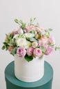 Rich bunch of composition in hatbox. A fresh bouquet flowers different colors mix