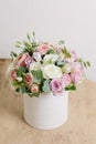 Rich bunch of composition in hatbox. A fresh bouquet flowers different colors mix