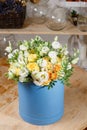 Rich bunch eustoma white and yellow roses of composition in hatbox. A fresh bouquet flowers different colors mix Royalty Free Stock Photo