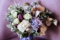 Rich bunch of pink peonies and lilac eustoma roses flowers, green leaf in glass vase. Royalty Free Stock Photo