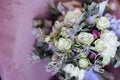 Rich bunch of pink peonies and lilac eustoma roses flowers, green leaf in glass vase. Royalty Free Stock Photo