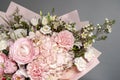 Rich bunch of pink and red flowers and lilac. Eustoma roses flowers, green leaf in glass vase. Fresh spring bouquet. Summer Royalty Free Stock Photo