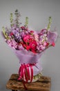 Rich bunch of pink and red flowers and lilac. Eustoma roses flowers, green leaf in glass vase. Fresh spring bouquet. Summer Royalty Free Stock Photo