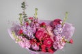 Rich bunch of pink and red flowers and lilac. Eustoma roses flowers, green leaf in glass vase. Fresh spring bouquet. Summer Royalty Free Stock Photo