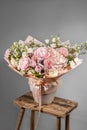 Rich bunch of pink and red flowers and lilac. Eustoma roses flowers, green leaf in glass vase. Fresh spring bouquet. Summer Royalty Free Stock Photo