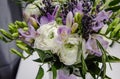 Rich bunch of violet fresia, white buttercup ranunculus peonies, green leaf, lilac lavender, roses, rosemary in bouquet