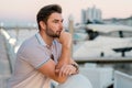 Rich business man dreaming and thinking near the yacht. Businessman in polo, outdoor business portrait. Business people