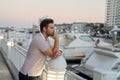 Rich business man dreaming and thinking near the yacht. Successful male model in big city living the urban lifestyle Royalty Free Stock Photo