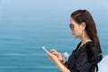 Rich business woman playing smart phone on luxury yacth. Royalty Free Stock Photo