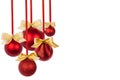 Rich christmas decoration - red balls with golden bows hanging as bunch on ribbons isolated on white background, copy space. Royalty Free Stock Photo