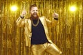 Rich chubby man in a golden suit dances at a party or disco on a bright shiny background.