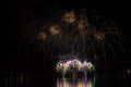 Rich and colorful fireworks over surface of Brno`s Dam with lake reflection Royalty Free Stock Photo