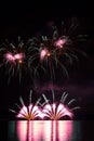 Rich and colorful fireworks over surface of Brno`s Dam with reflection on the surface of lake Royalty Free Stock Photo