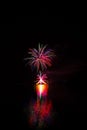 Rich and colorful fireworks over surface of Brno`s Dam with reflection on the surface of lake Royalty Free Stock Photo