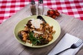 Rich Seafood Pasta on Wooden Board With Red Checkered Tablecloth