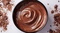 Rich creamy chocolate spread in bowl with dark chocolate shavings on white background Royalty Free Stock Photo