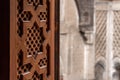 Rich decorated window shutter at the courtyard of an oriental madrasa