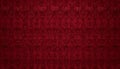 A rich deep red background, with a repeating damask pattern