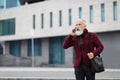 Rich elderly man talking on phone on the street