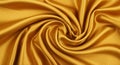 Rich gold satin fabric elegantly draped, creating a spiral pattern. The smooth Royalty Free Stock Photo