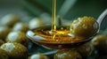 Olive Oil Drizzling onto Fresh Olives Wooden Spoon. Royalty Free Stock Photo