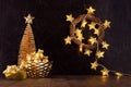 Rich  home interior - golden decoration for christmas - christmas tree, glowing lights, stars, wreath, balls, gift box, ribbons. Royalty Free Stock Photo