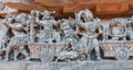 Rich indian people traveling by horse carts, on wall with old relief. 12th century Hindu Hoysaleshwara temple in India Royalty Free Stock Photo