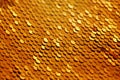 Rich luxurious golden macro texture of yellow metallic gold scale sequin beads. Christmas  New Year festive holiday shiny Royalty Free Stock Photo