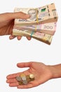 Rich man with banknotes and poor woman with coins. Income inequality concept. Hands hold hryvnia, the money of Ukraine. Isolated Royalty Free Stock Photo